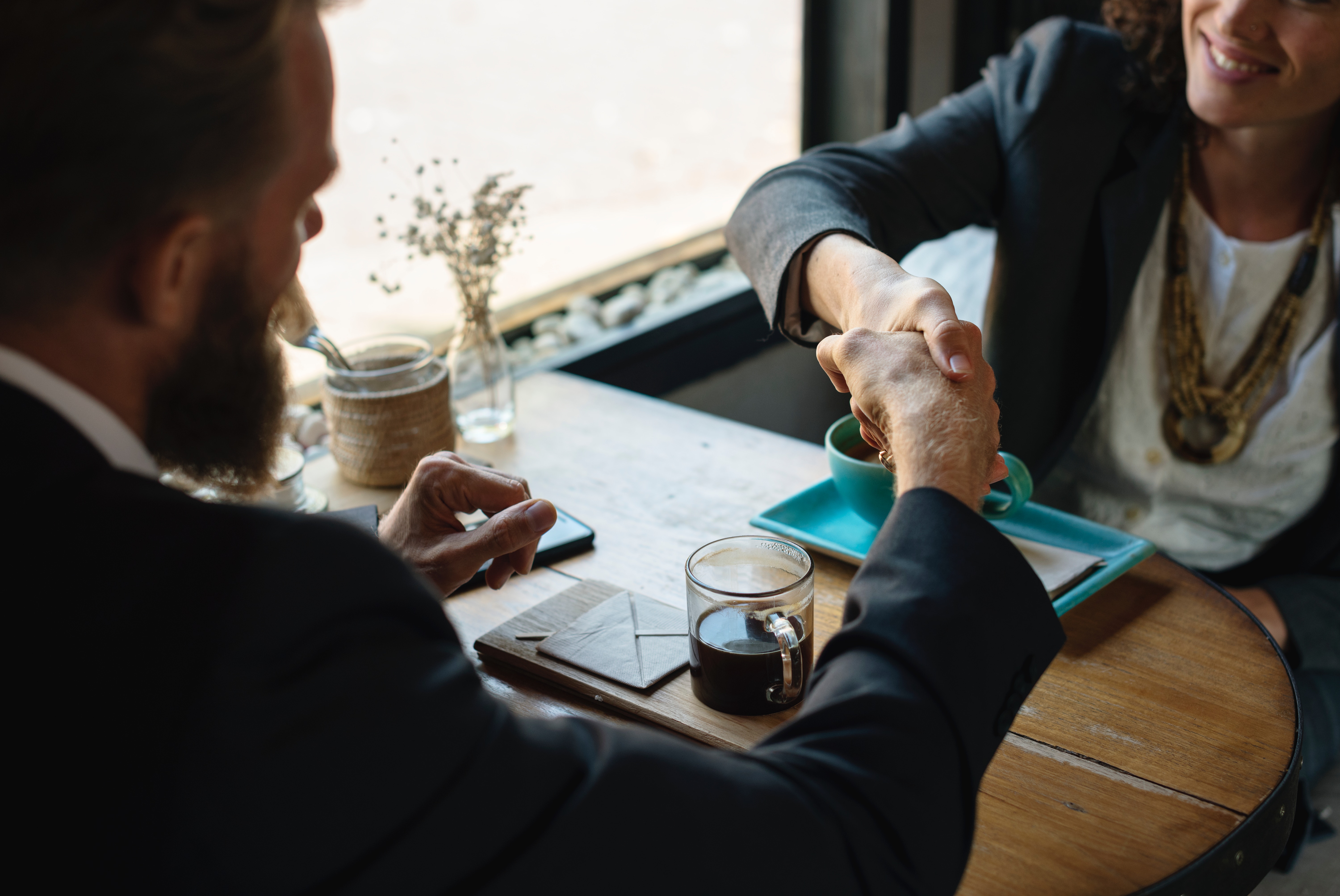 A business meeting concluding with a handshake